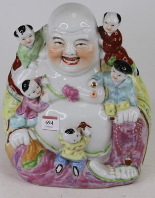 Lot 694 - A Chinese porcelain figure of Buddha amongst...