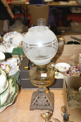 Lot 668 - A Victorian cast iron oil lamp, having an acid...