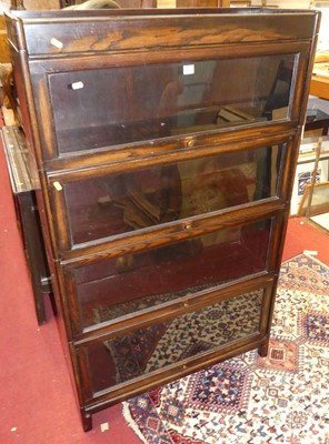 Lot 1209 - A 1930s oak four tier stacking book case,...