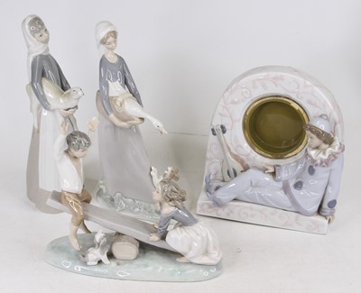 Lot 616 - A Lladro porcelain figure of a boy and girl on...