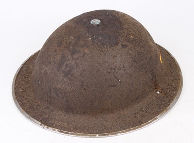 Lot 578 - A WWII British military helmet, having typical...