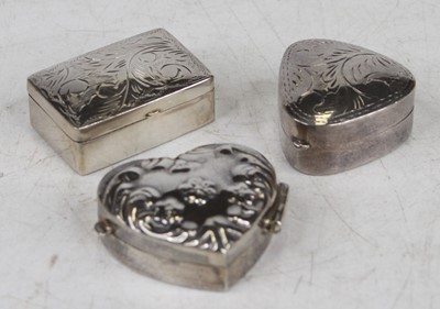 Lot 387 - A modern silver and embossed heart shaped pill...