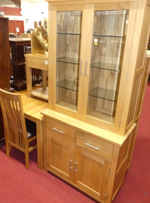 Lot 1276 - A contemporary light oak dining suite...