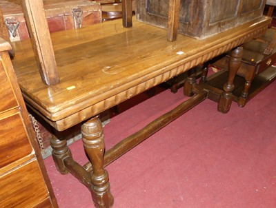 Lot 1299 - A joined oak narrow dining table, having...