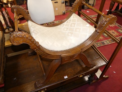 Lot 1300 - A decorative carved mahogany X-frame dressing...