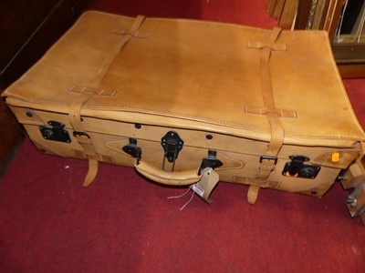 Lot 1083 - A stitched hide suitcase with metal fittings