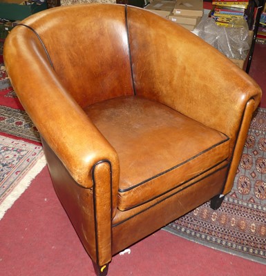 Lot 1330 - A contemporary tan leather tub armchair,...