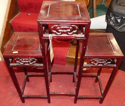 Lot 1359 - A Chinese hardwood three-tier vase stand, with...