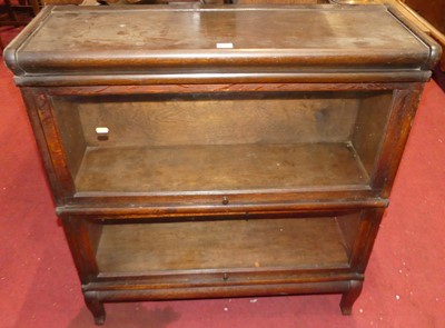 Lot 1360 - A 1930s oak two-tier stacking bookcase, having...