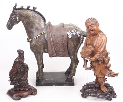 Lot 34 - A Chinese carved hardwood figure of a man...