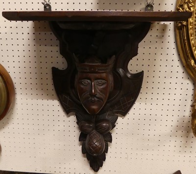 Lot 1169 - An early 20th century carved oak wall bracket,...