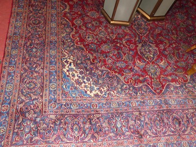 Lot 1183 - A Persian woollen red and blue ground Tabriz...