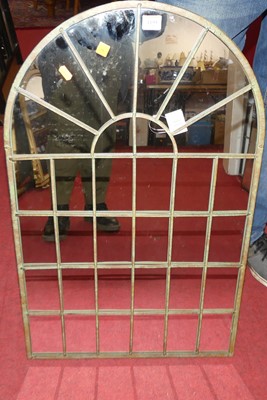 Lot 1195 - A contemporary metal framed arched wall mirror,...