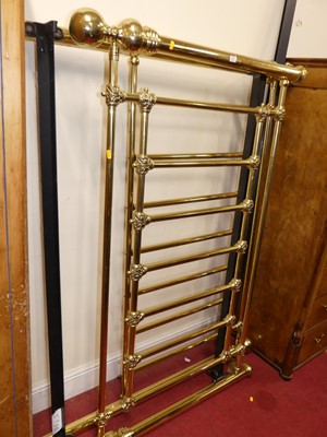 Lot 1199 - A contemporary polished tubular brass double...