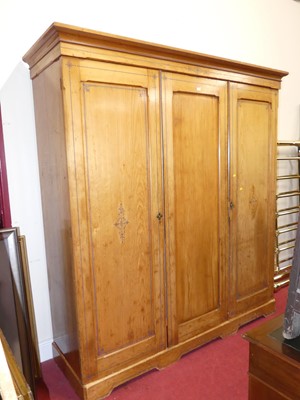 Lot 1200 - A Victorian ash triple wardrobe, enclosing...