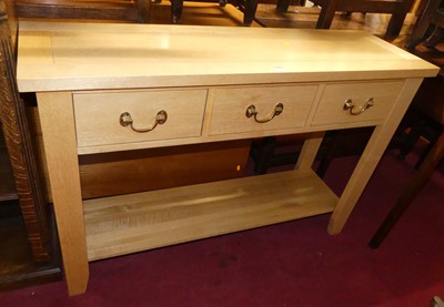 Lot 1225 - A contemporary blond oak three drawer two-tier...