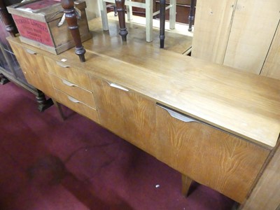 Lot 1287 - A 1960s teak long sideboard, having three...