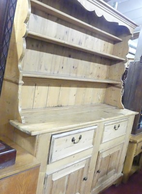 Lot 1289 - A rustic pine kitchen dresser, having a...