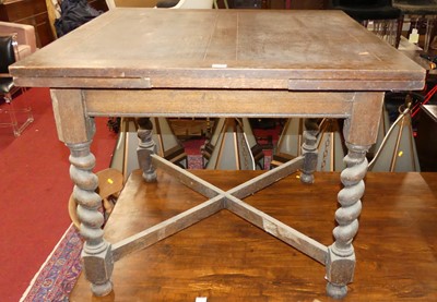 Lot 1340 - A 1930s oak barleytwist drawleaf dining table