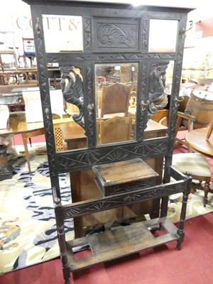 Lot 1210 - A circa 1900 ebonised oak and line carved...