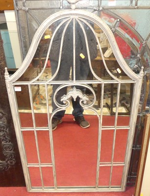 Lot 1074 - A metal framed garden mirror, surmounted with...