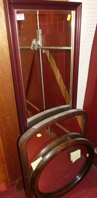 Lot 1069 - An oak framed and bevelled oval wall mirror;...