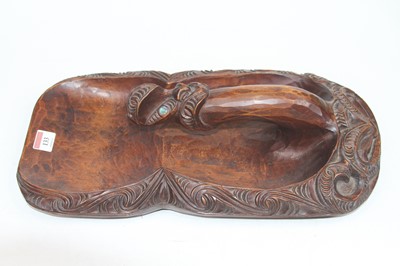 Lot 133 - A Maori carved wood and mother of pearl inlaid...