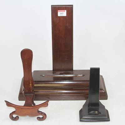 Lot 143 - A mahogany charger stand, h.32cm; together...