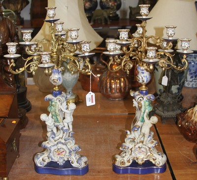 Lot 154 - A pair of porcelain and gilt metal table...