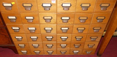 Lot 1415 - A 1930s blond oak bank of 36 index filing...