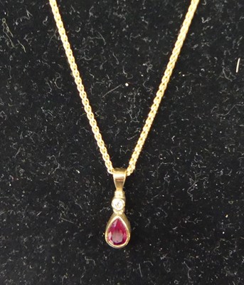 Lot 321 - A modern 9ct gold ruby and diamond set pendant...