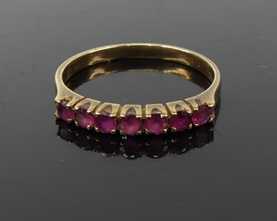 Lot 339 - A modern 9ct gold and ruby set half eternity...