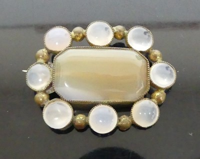 Lot 347 - A pinchbeck chalcedony oval panelled brooch,...