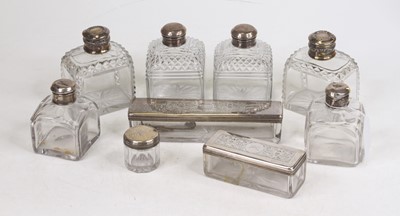 Lot 255 - A collection of nine silver lidded glass...