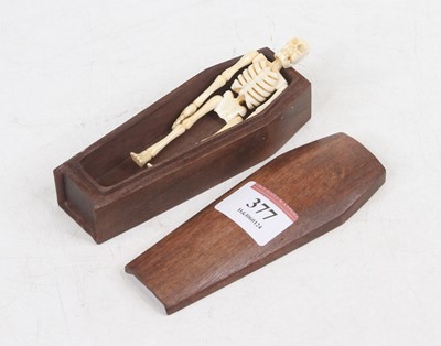 Lot 377 - A reproduction miniature faux ivory model of a...