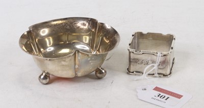 Lot 301 - A silver napkin ring of square section,...