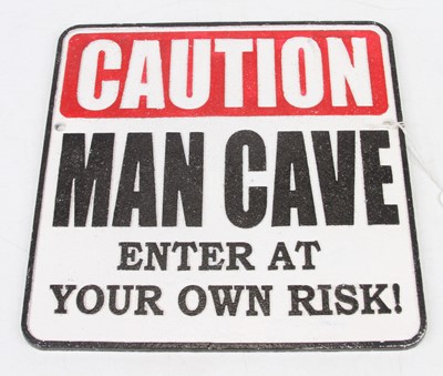 Lot 486 - A cast iron sign 'Caution Man Cave - Enter at...