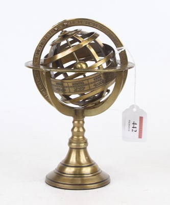 Lot 442 - A reproduction bronzed metal zodiac globe,...