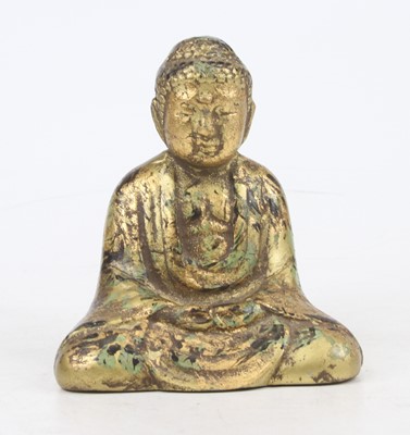 Lot 443 - A gilt metal seated deity, 13.5cm