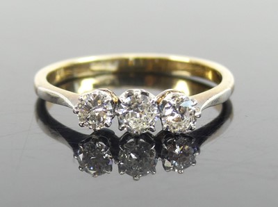 Lot 1292 - A yellow and white metal diamond three-stone...