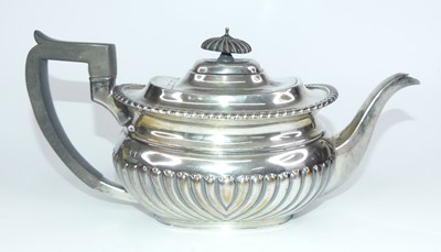 Lot 1199 - An Edward VII silver teapot, of half reeded...