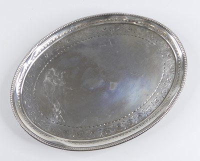 Lot 1151 - A George III silver teapot stand, of oval form,...