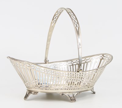 Lot 1195 - An Edwardian silver swing-handled basket, of...