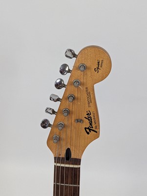 Lot 521 - A Squier by Fender stratocaster electric...