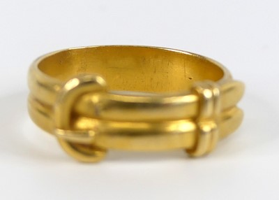 Lot 2517 - A yellow metal double strand buckle ring,...