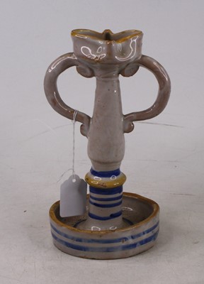 Lot 22 - An Italian tin-glazed earthenware candlestick,...