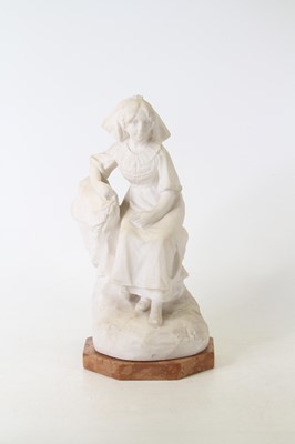 Lot 36 - A carved marble figure of a seated girl,...