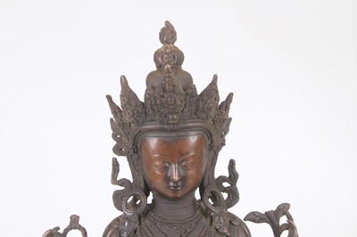 Lot 47 - A bronzed metal figure of Tara, shown seated,...