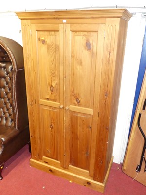 Lot 1124 - A modern pine double door wardrobe, having...