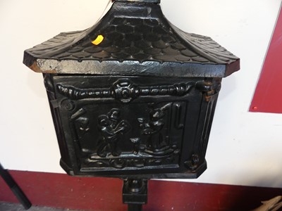 Lot 1187 - A black painted cast iron freestanding...